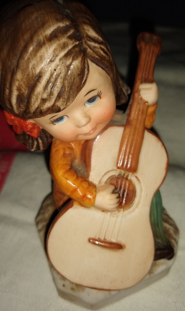 Moppets vintage girl playing guitar figurine.